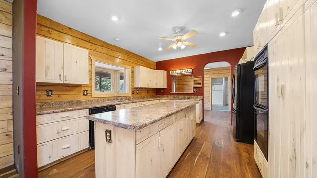 a kitchen with stainless steel appliances granite countertop a sink and granite counter tops