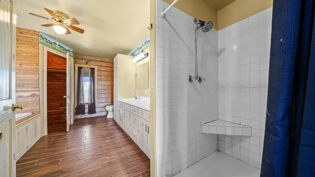 a bathroom with a tub a sink and a large mirror