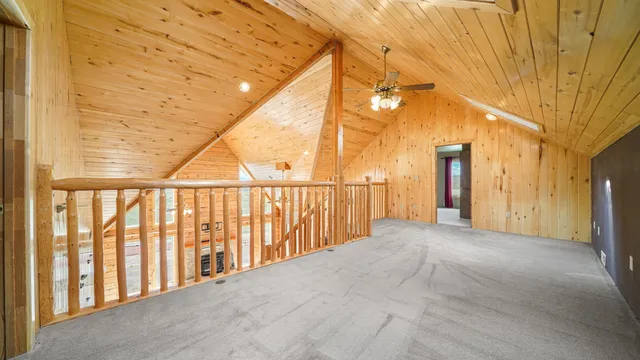 a view of an empty room with a ceiling fan