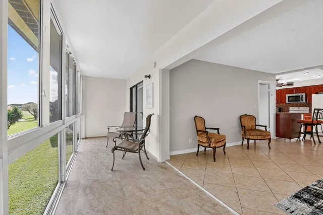 a view of a room that has a large window and chair