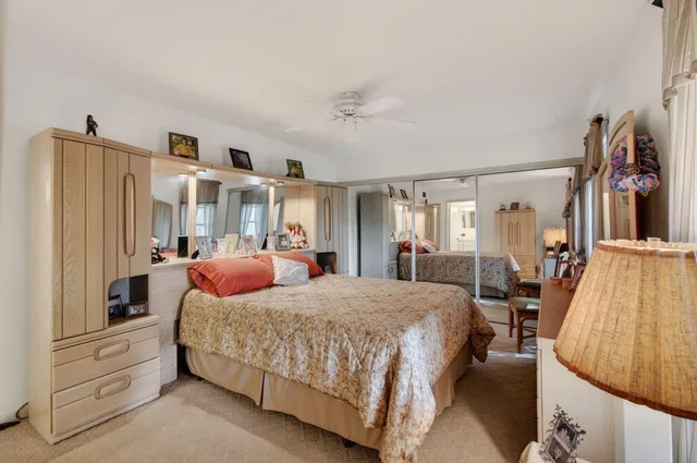 a bedroom with a bed and dresser with mirror