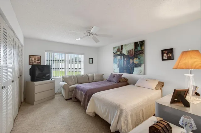 a bedroom with two beds and a couch