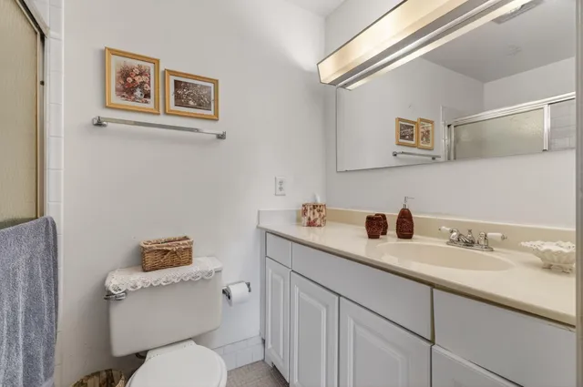 a bathroom with a toilet sink and mirror
