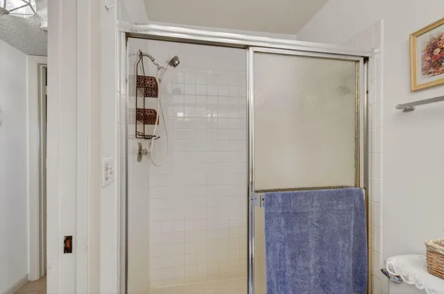 a bathroom with a glass shower door