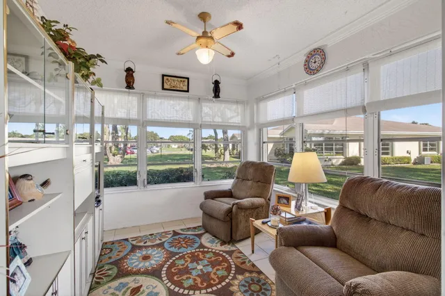 a living room with furniture ceiling fan and a rug