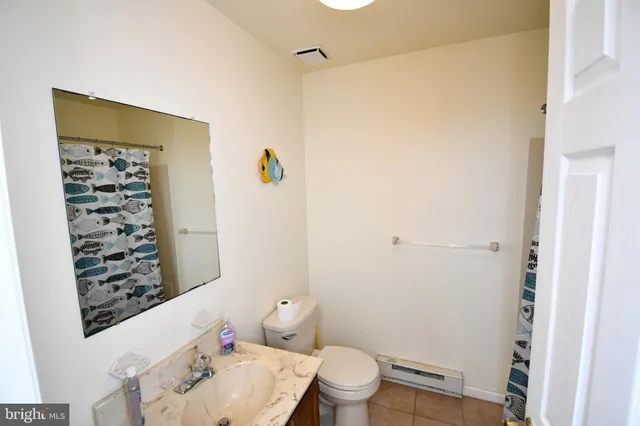 a white toilet sitting next to a bathroom sink