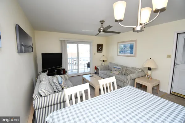 a bedroom with two beds and a flat screen tv