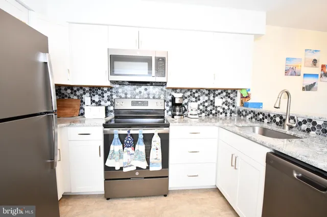 a kitchen with a sink stove and refrigerator