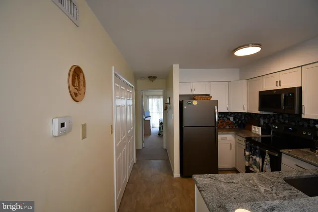 a kitchen with a refrigerator a microwave a stove and cabinets