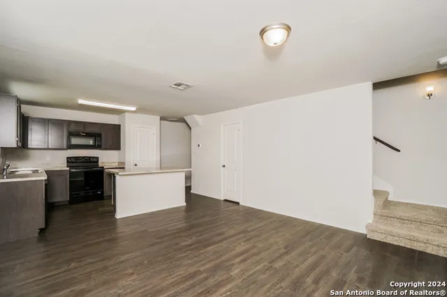 a view of kitchen with sink microwave and stove