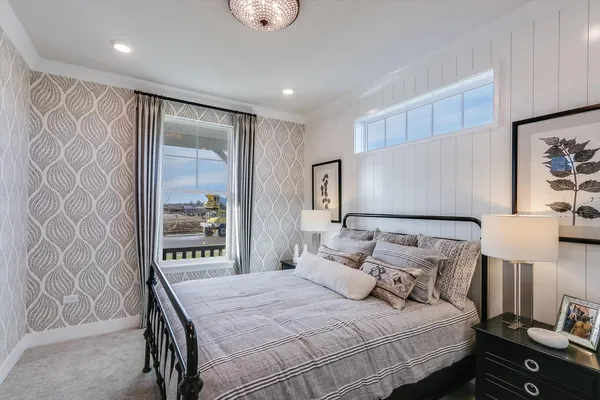 a bedroom with a bed and a lamp