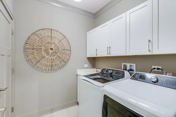 a kitchen with a sink a stove and cabinets