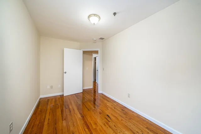 a bathroom with a bathtub shower sink mirror and toilet