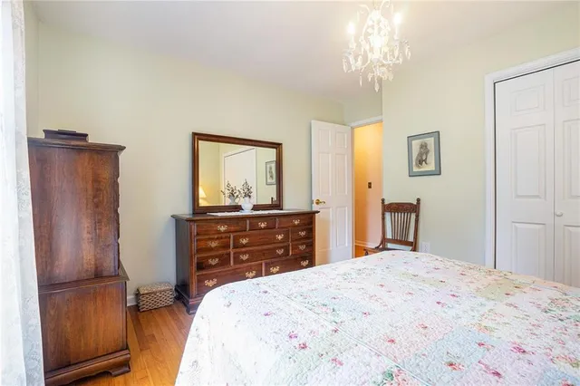 a bedroom with a bed and a dresser in it