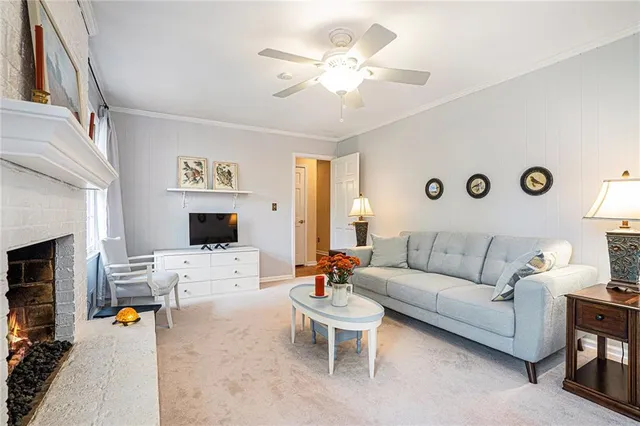 a living room with furniture kitchen view and a fireplace