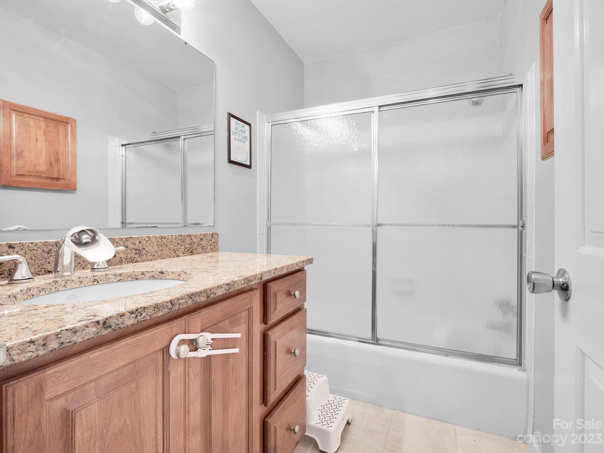8072 Knights Bridge Road Charlotte, NC 28210 - Photo 16 of 23 a bathroom with a granite countertop sink mirror and vanity