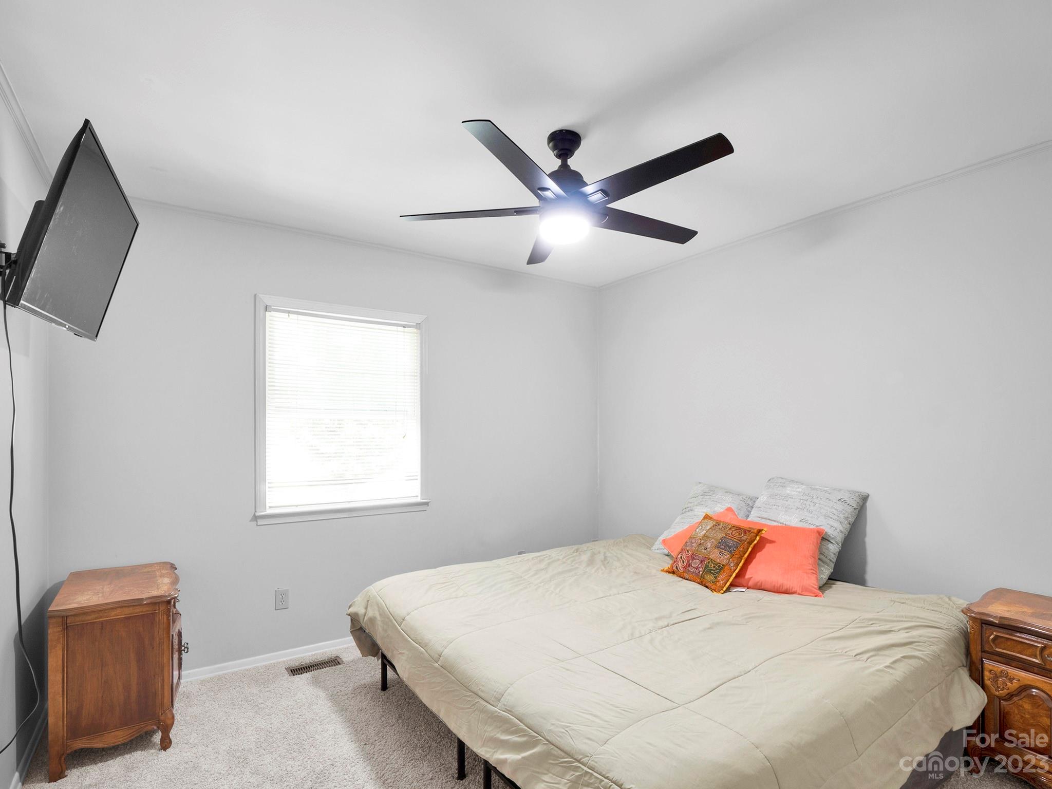 8072 Knights Bridge Road Charlotte, NC 28210 - Photo 17 of 23 a bedroom with a bed and a ceiling fan