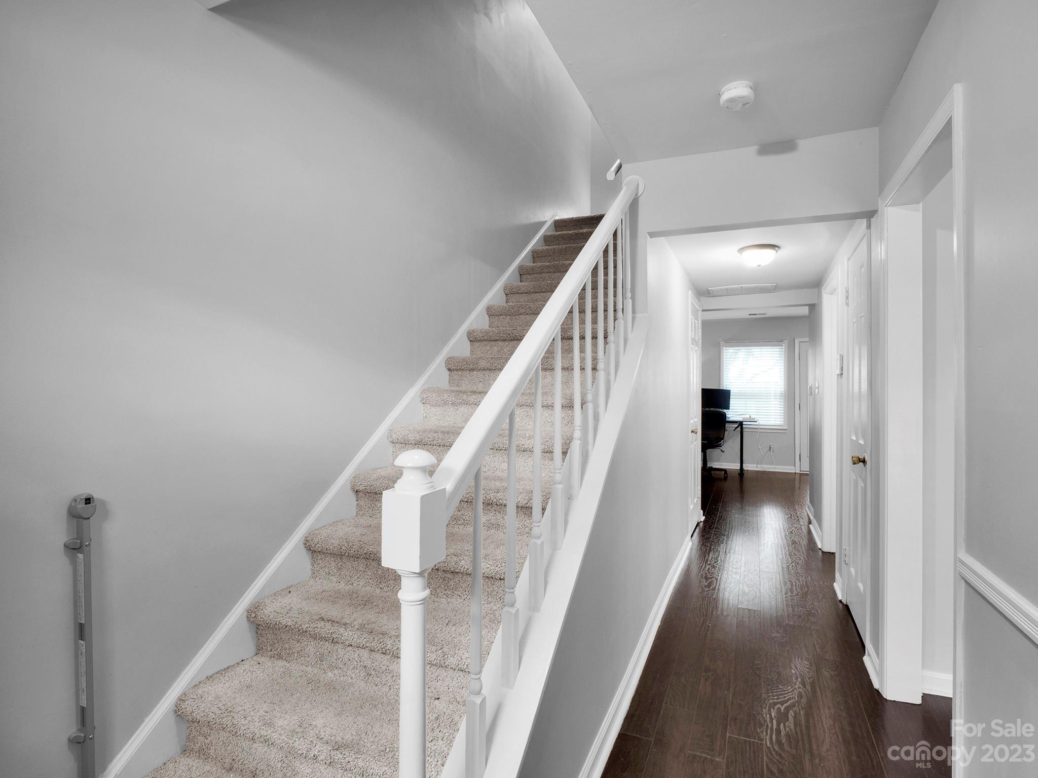 8072 Knights Bridge Road Charlotte, NC 28210 - Photo 2 of 23 a view of a hallway with wooden floor and stairs