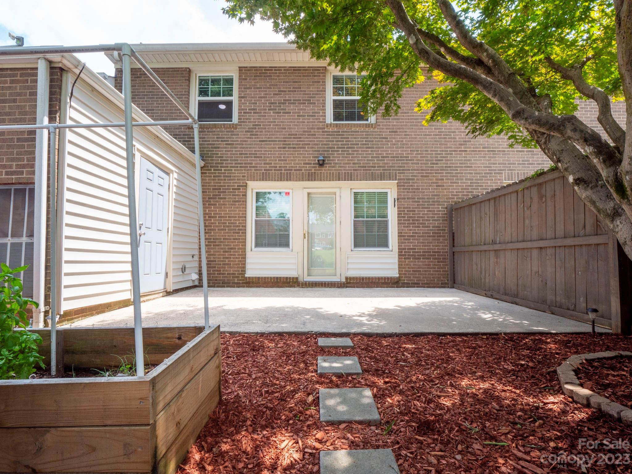 8072 Knights Bridge Road Charlotte, NC 28210 - Photo 21 of 23 a view of a house with a backyard