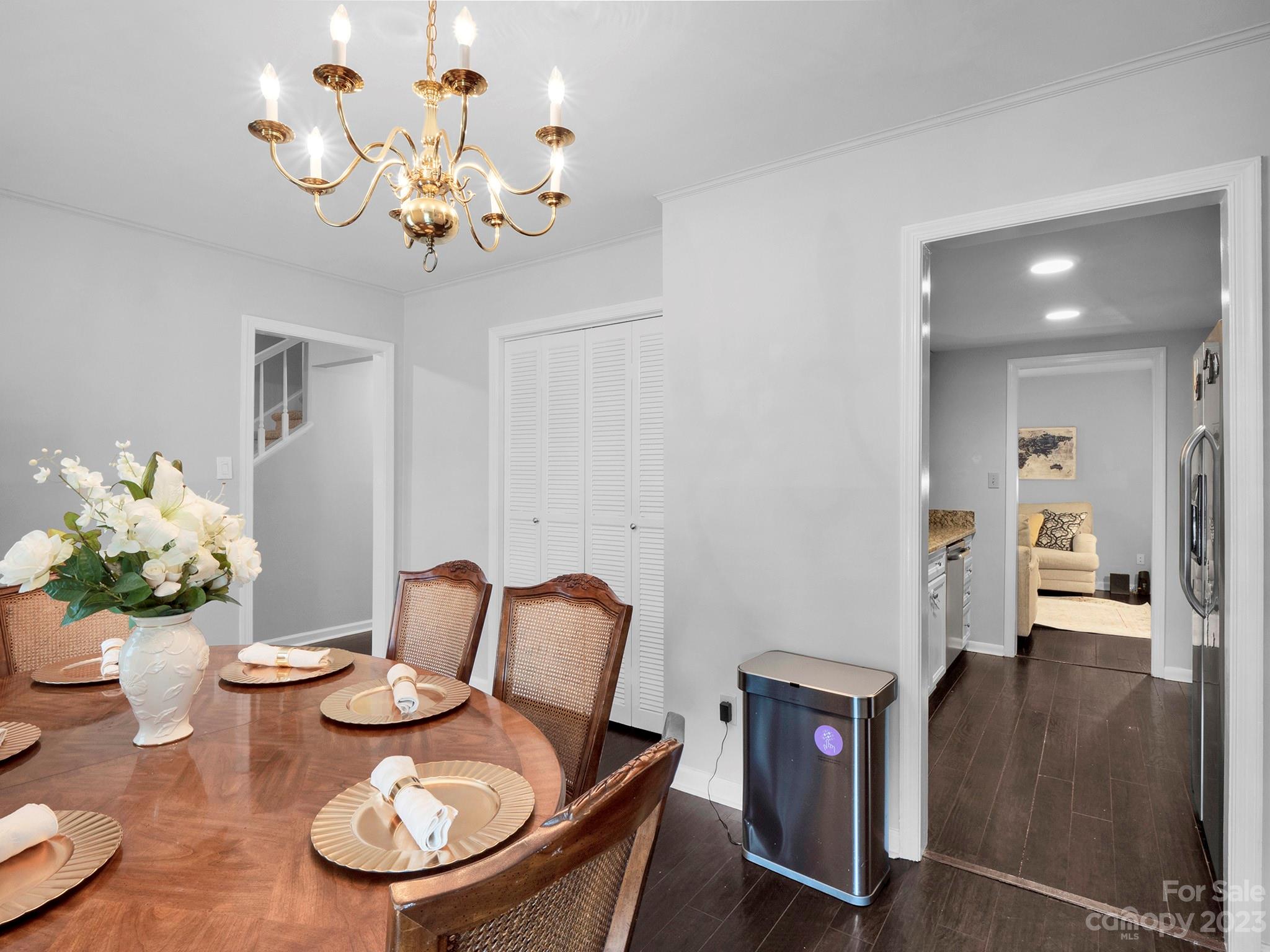 8072 Knights Bridge Road Charlotte, NC 28210 - Photo 5 of 23 a view of a dining room with furniture a chandelier and wooden floor