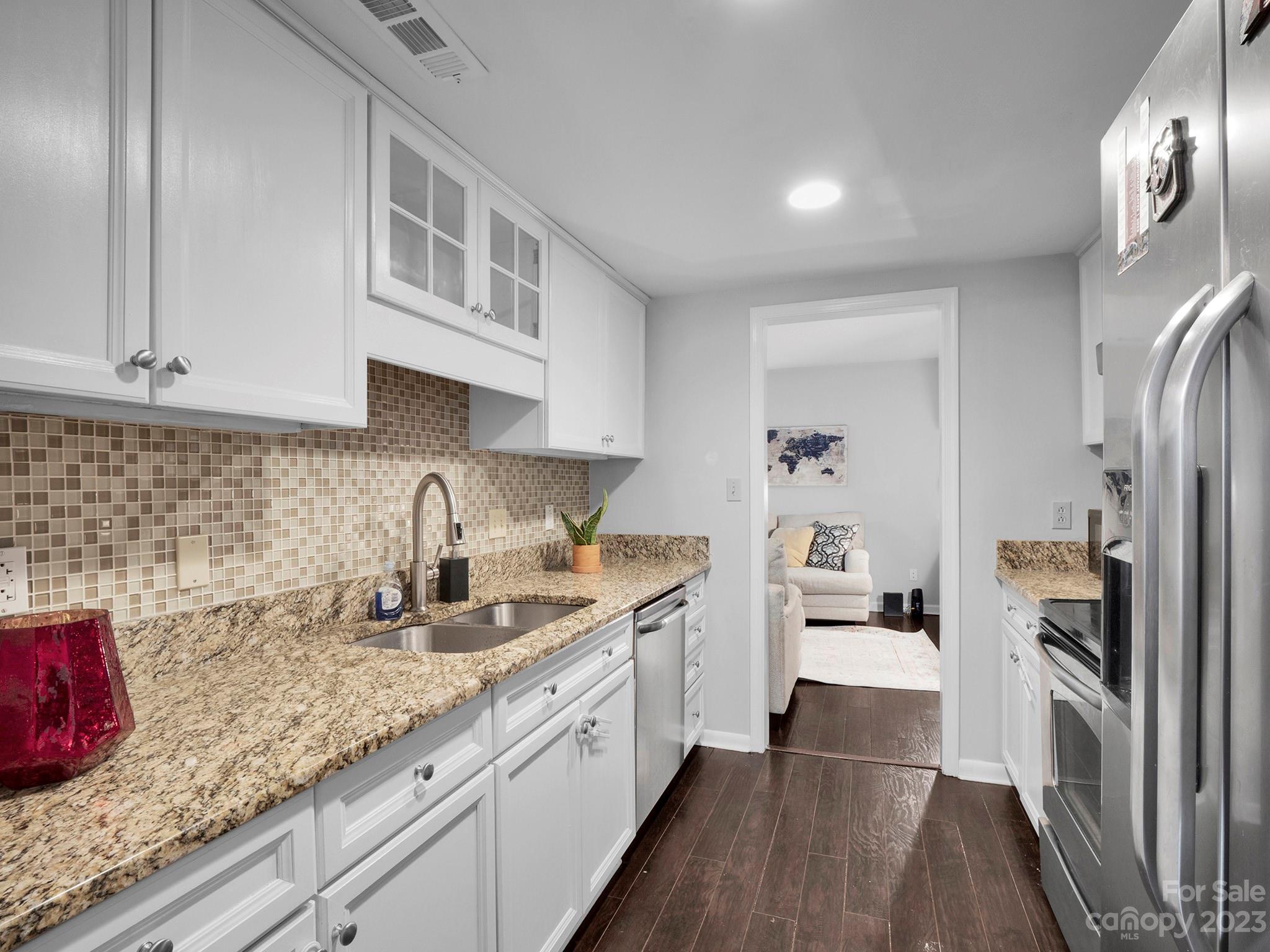 8072 Knights Bridge Road Charlotte, NC 28210 - Photo 7 of 23 a kitchen with granite countertop a sink a counter space and cabinets