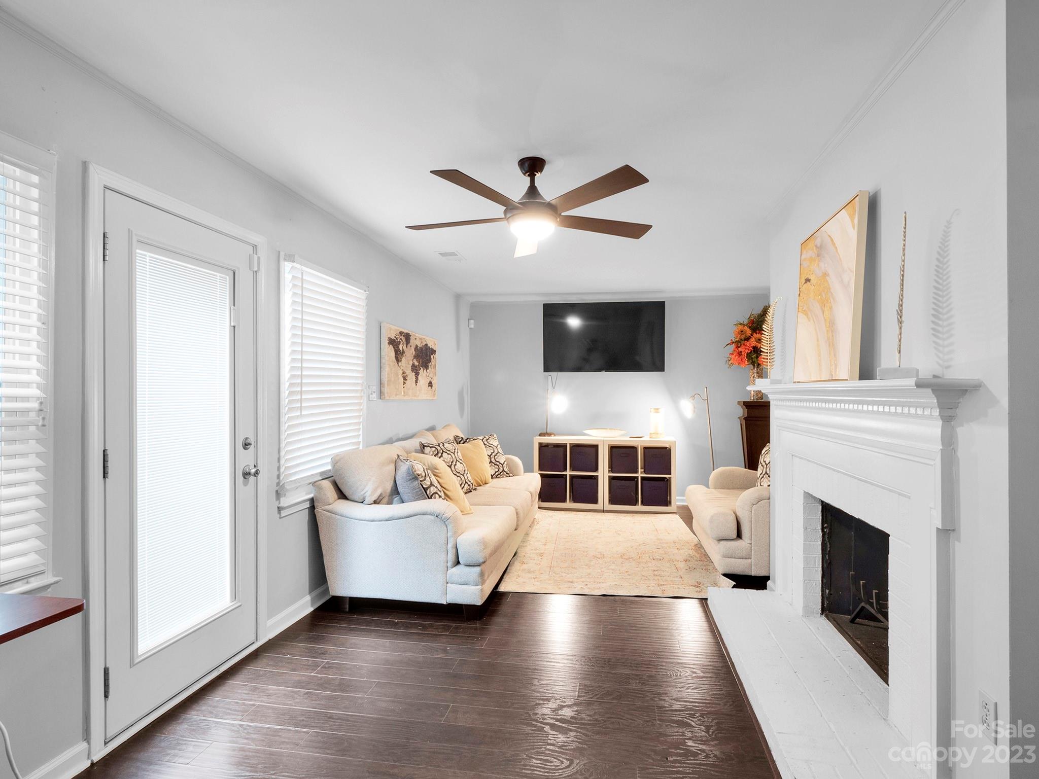 8072 Knights Bridge Road Charlotte, NC 28210 - Photo 10 of 23 a living room with furniture a fireplace and a flat screen tv