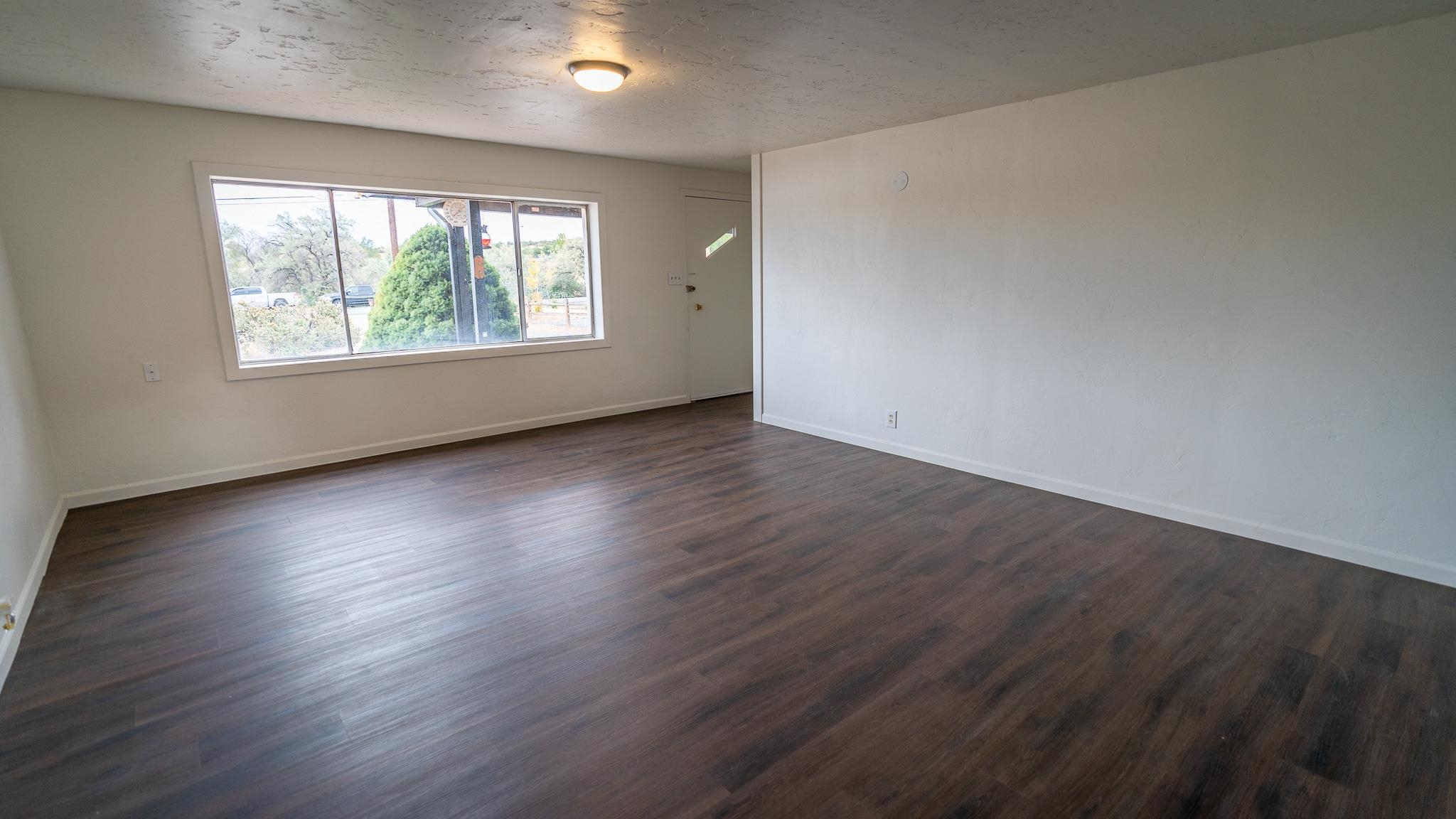 441 South Camp Road Grand Junction, CO 81507 - Photo 12 of 36 an empty room with wooden floor and windows