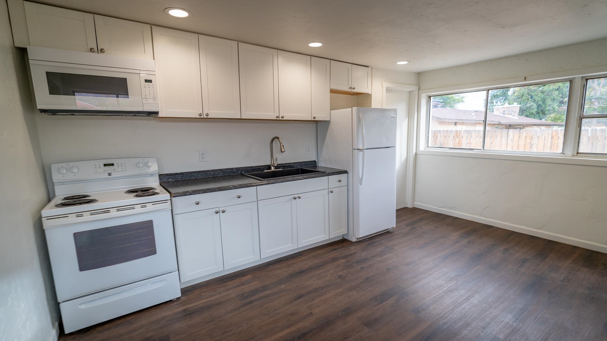 441 South Camp Road Grand Junction, CO 81507 - Photo 16 of 36 a kitchen with stainless steel appliances granite countertop a stove a sink and a microwave