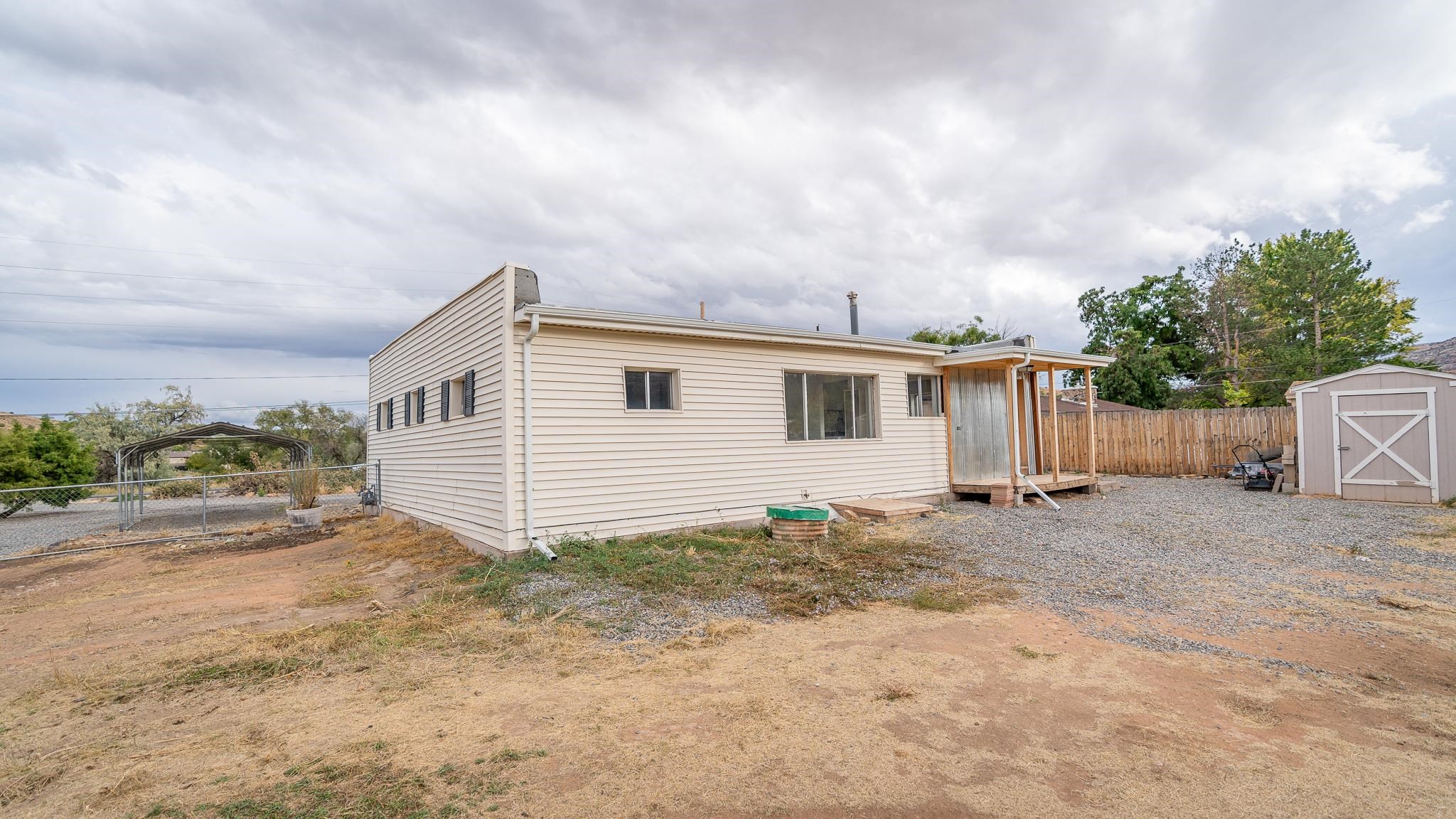441 South Camp Road Grand Junction, CO 81507 - Photo 7 of 36 a view of a house with backyard and bushes