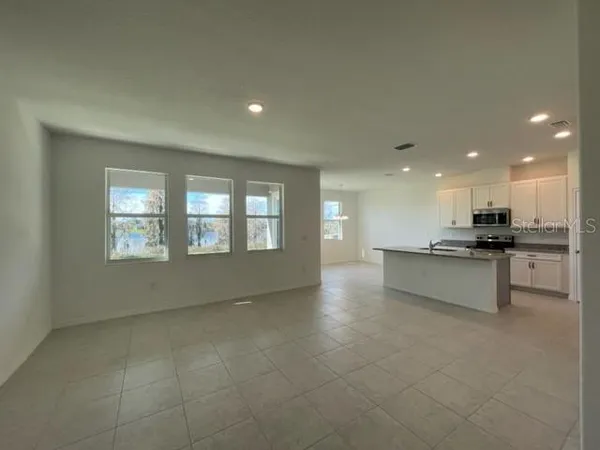 a view of kitchen with refrigerator and window