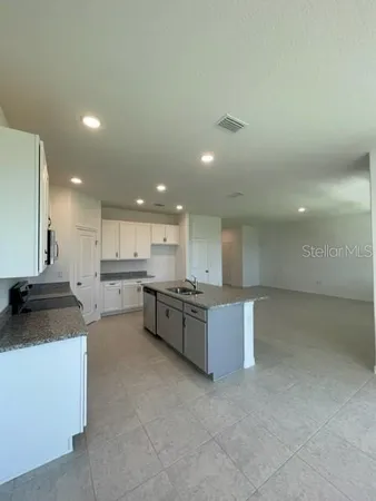 a kitchen with a sink and a stove top oven