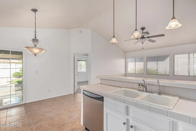 a view of a kitchen with a sink cabinetry and a chandelier