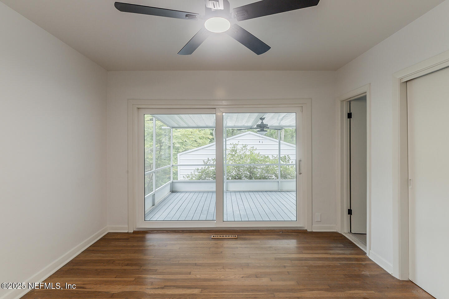 6508 Colgate Road Jacksonville, FL 32217 - Photo 10 of 15 an empty room with wooden floor and windows