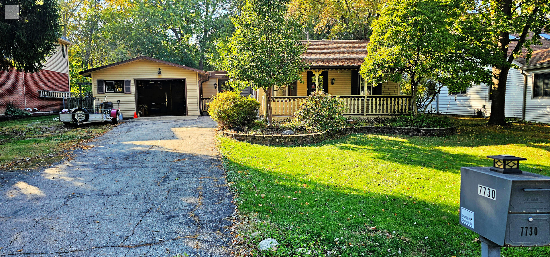 7730 Virginia Court Willowbrook, IL 60527 - Photo 2 of 33 a front view of a house with swimming pool and porch