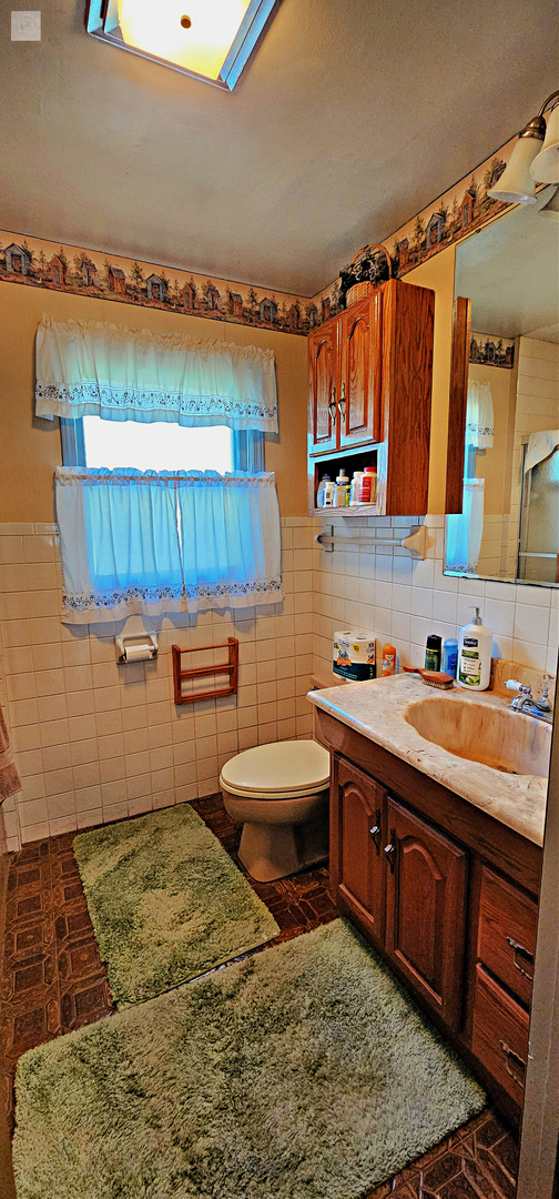 7730 Virginia Court Willowbrook, IL 60527 - Photo 21 of 33 a room with a sink and a mirror