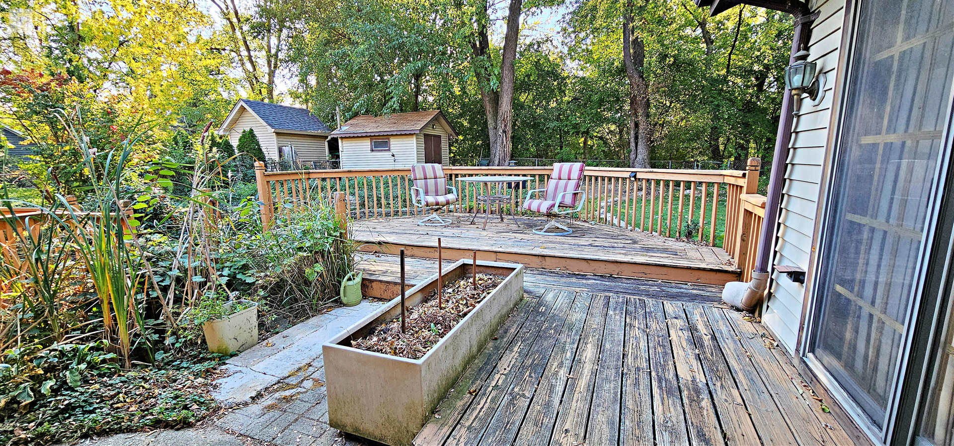 7730 Virginia Court Willowbrook, IL 60527 - Photo 33 of 33 a balcony with wooden floor table and chairs in a patio