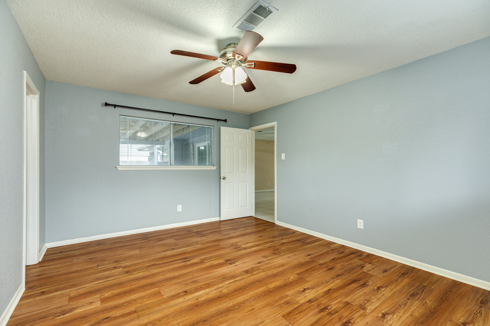 128 Houston Street Angleton, TX 77515 - Photo 21 of 25 a view of a big room with wooden floor and windows