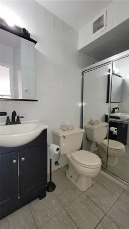 a bathroom with a sink toilet and mirror