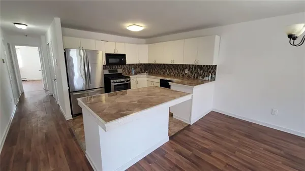 a kitchen with a sink and refrigerator