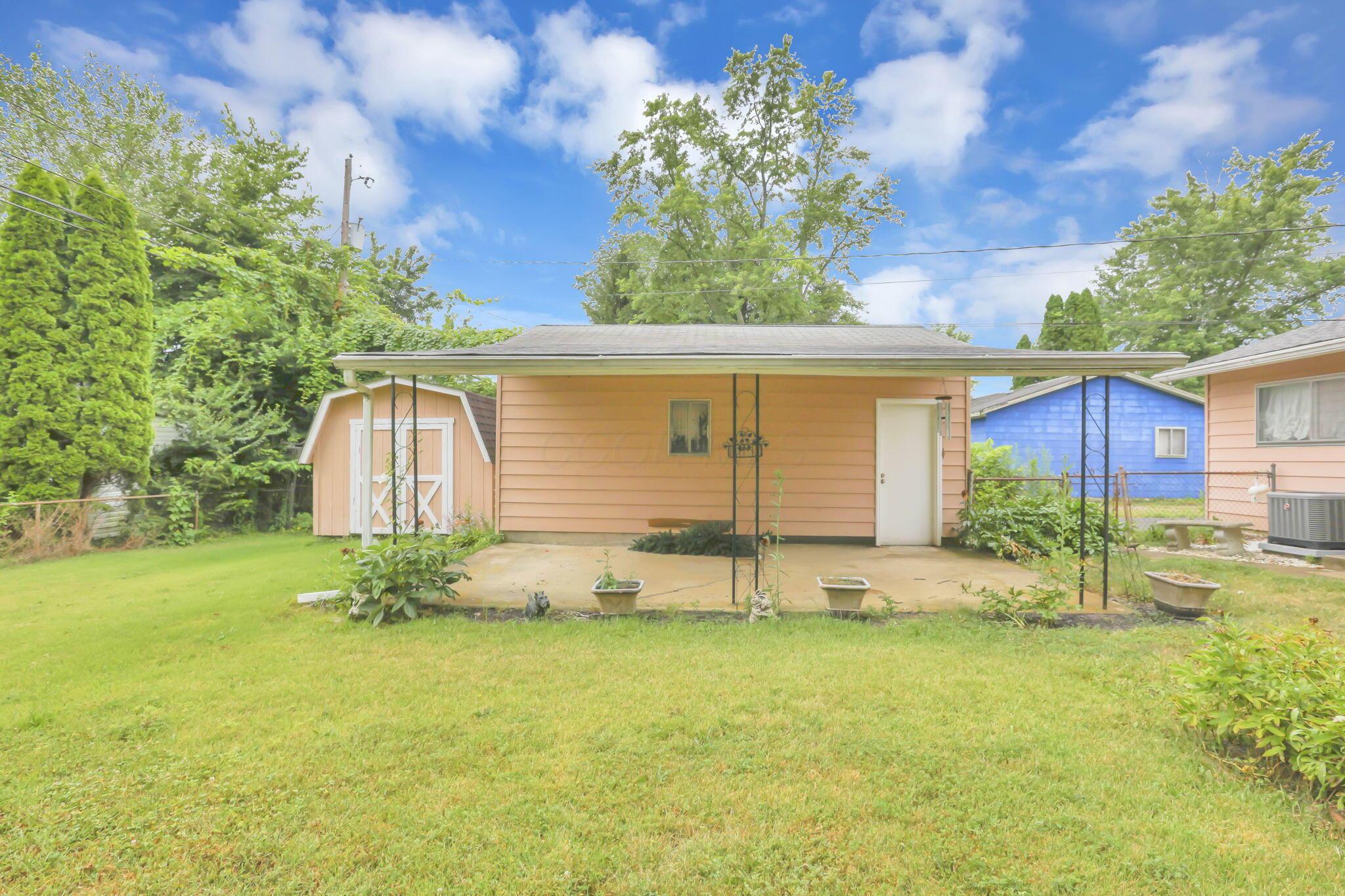 3882 Glenfield Road Columbus, OH 43232 - Photo 27 of 29 Expansive green lawn with a concrete patio and covered area