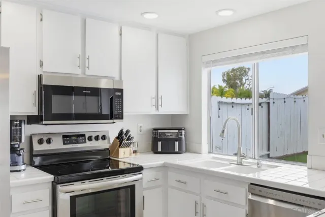 a kitchen with granite countertop a stove and a sink