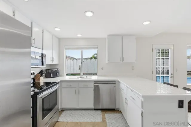 a kitchen with a sink stove and cabinets