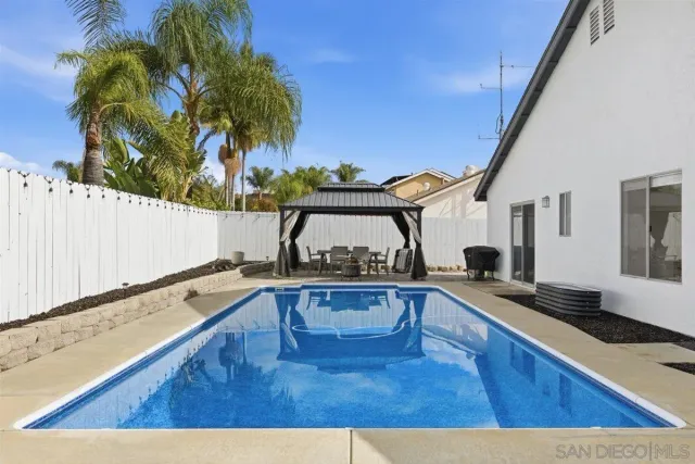 a living room with furniture and a kitchen view