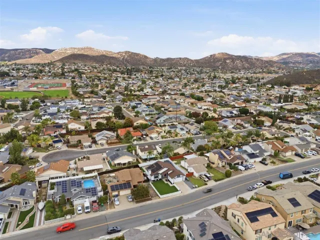 an aerial view of residential houses with city view