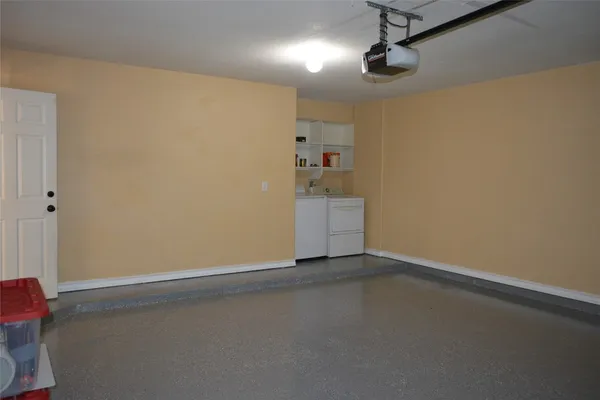 an empty room with chandelier fan