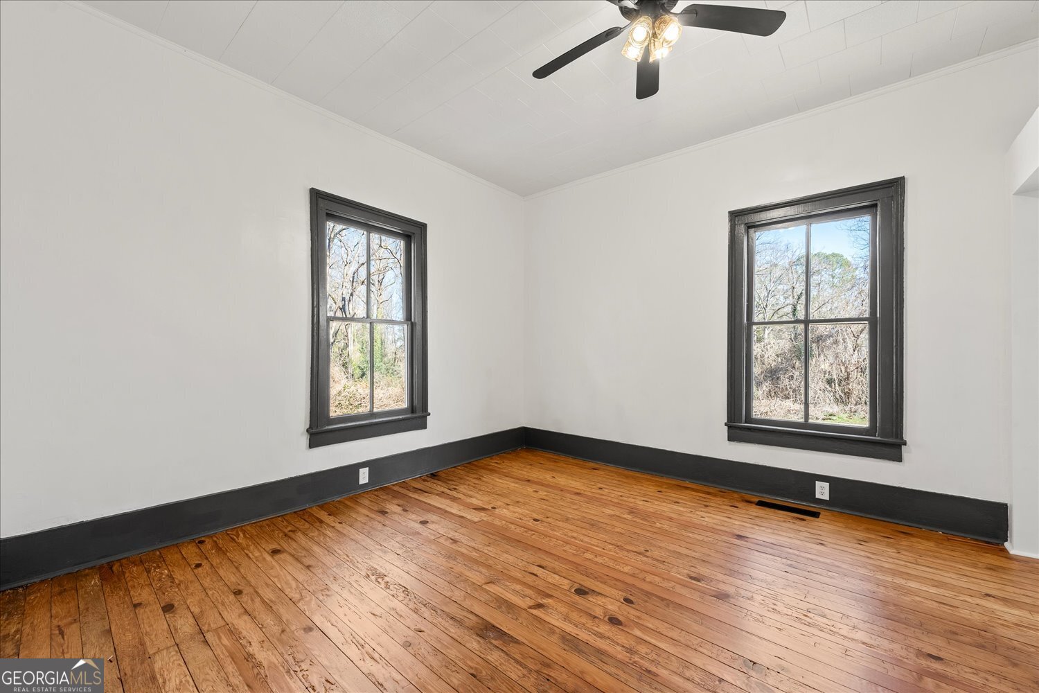 528 North Alexander Avenue Washington, GA 30673 - Photo 16 of 42 a view of an empty room with window and wooden floor