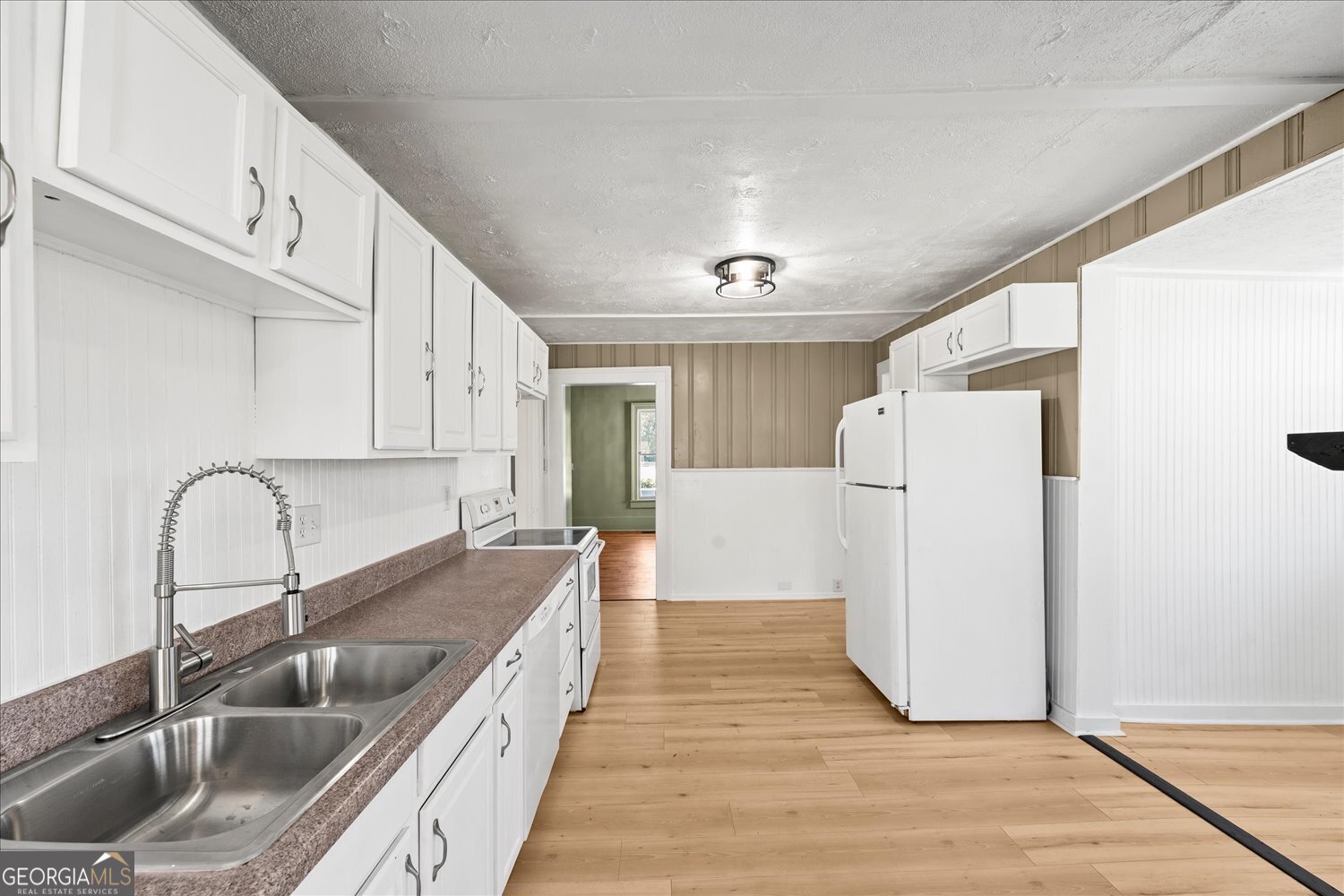 528 North Alexander Avenue Washington, GA 30673 - Photo 23 of 42 a kitchen with a refrigerator and a sink