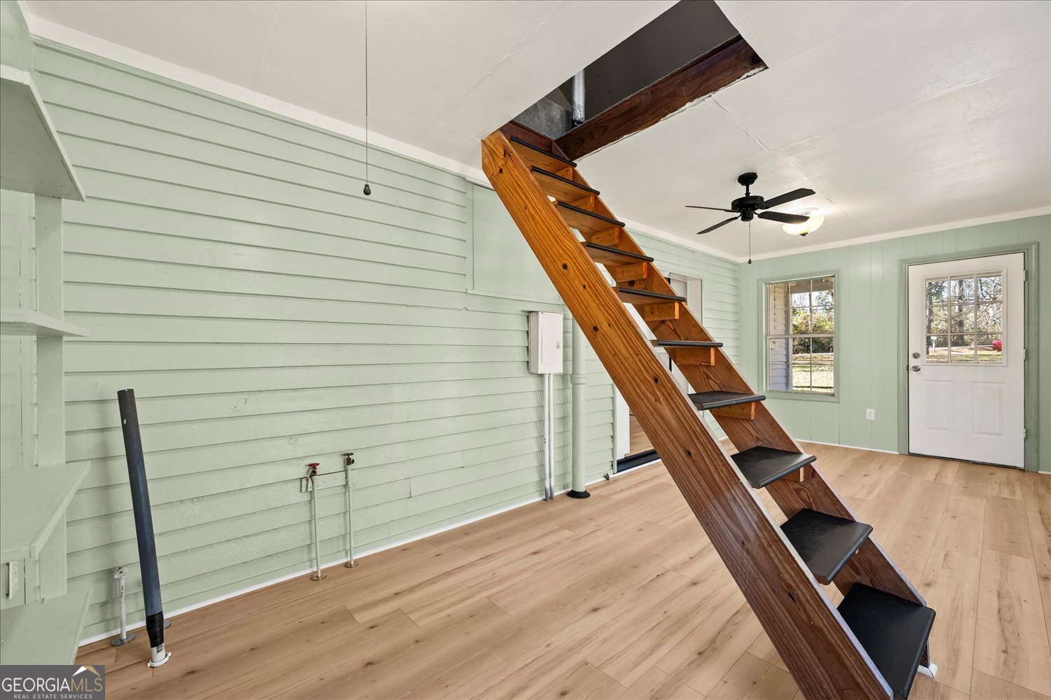 528 North Alexander Avenue Washington, GA 30673 - Photo 25 of 42 a very nice looking room with wooden floor and stairs