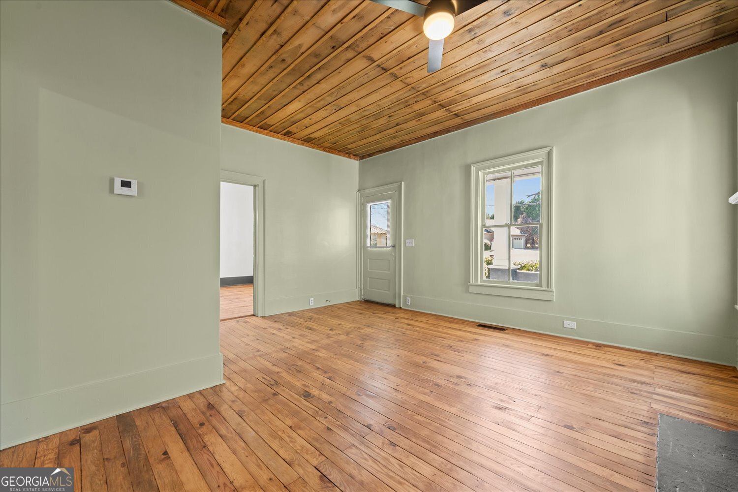 528 North Alexander Avenue Washington, GA 30673 - Photo 6 of 42 a view of empty room with wooden floor and fan