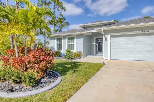 a view of a house with a small yard and plants